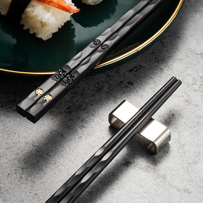 Elegant black and golden chopsticks set for sushi and Asian cuisine, perfect for Christmas and New Year gifts. Made from PET plastic and fiberglass with a textured grip. Great for men and women.