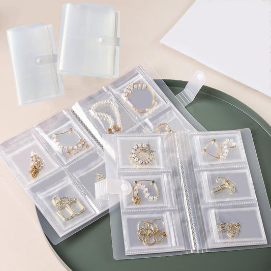 Transparent Jewelry Organizer Book with 84/160 Grids - Antioxidant Storage Case for Rings, Necklaces, Earrings, and Bracelets. Includes Portable Travel Pouch with Snap Closure and Utility Hooks for added convenience.