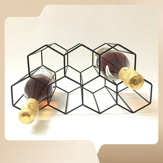 Elegant black metal honeycomb wine rack holds 7 bottles with a hexagonal grid design for living room or kitchen display.