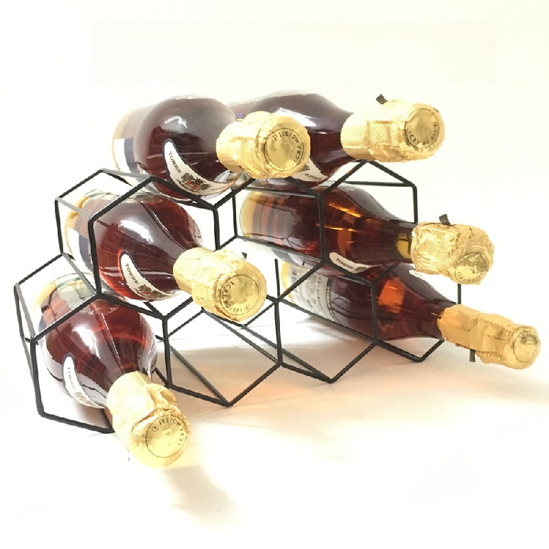 Elegant black metal honeycomb wine rack holds 7 bottles with a hexagonal grid design for living room or kitchen display.