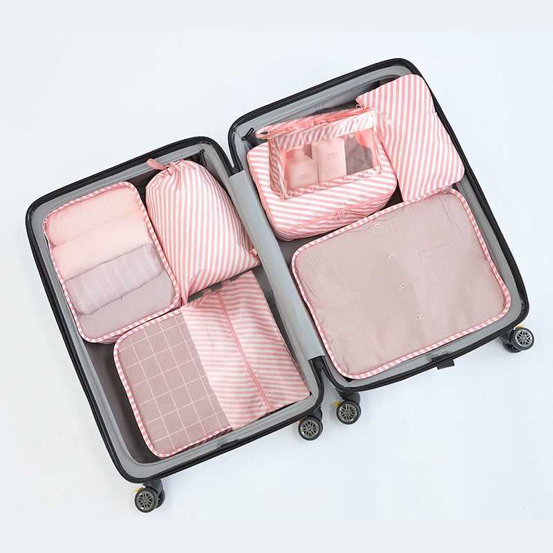 Pink Travel Organizer Set with 8 pieces, adjustable straps, zip closure, and "WISH U HAVE A COLORFUL LIFE" motif, made of polyester for luggage and toiletries.