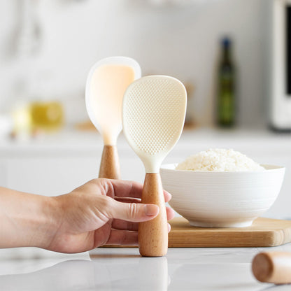 Silicone spoon with wooden handle, ideal for nonstick pans, rice cookers, and various cooking needs in home kitchens, school dormitories, and more.