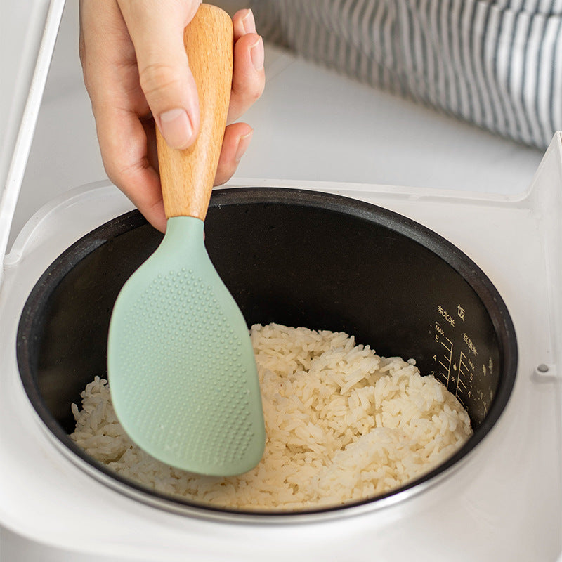 Silicone spoon with wooden handle, ideal for nonstick pans, rice cookers, and various cooking needs in home kitchens, school dormitories, and more.