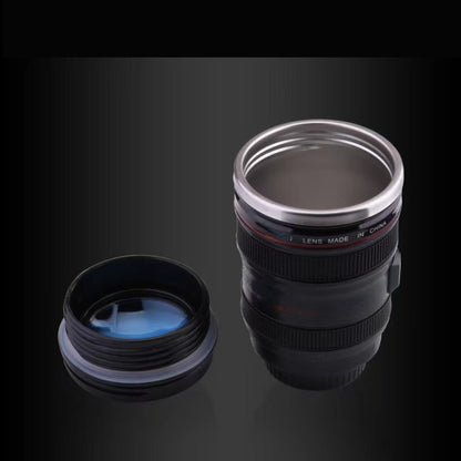 Stainless steel camera lens coffee mug with retractable lid, realistic SLR design. BPA-free ABS plastic. Ideal gift for photographers. Multipurpose travel cup. Hand wash only. Novelty drinkware.