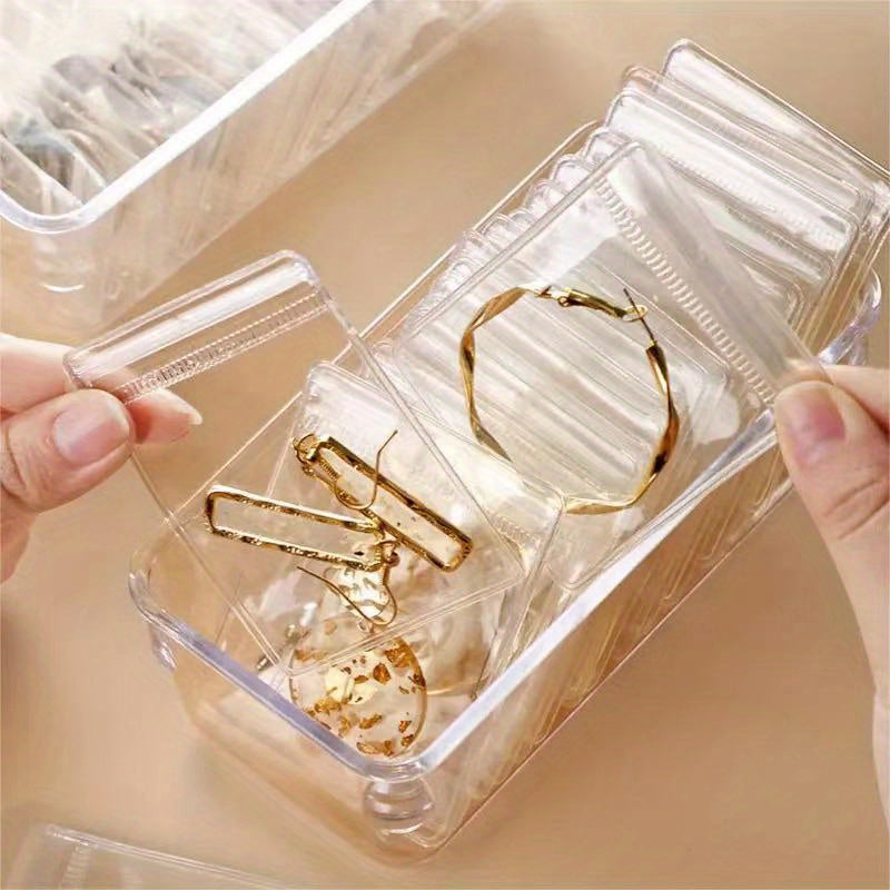 40pcs anti-oxidation jewelry box containing earrings, ear studs, necklaces, and rings. Transparent drawer for storage. Ideal as home decor or gifts for Christmas, New Year, and both men and women.