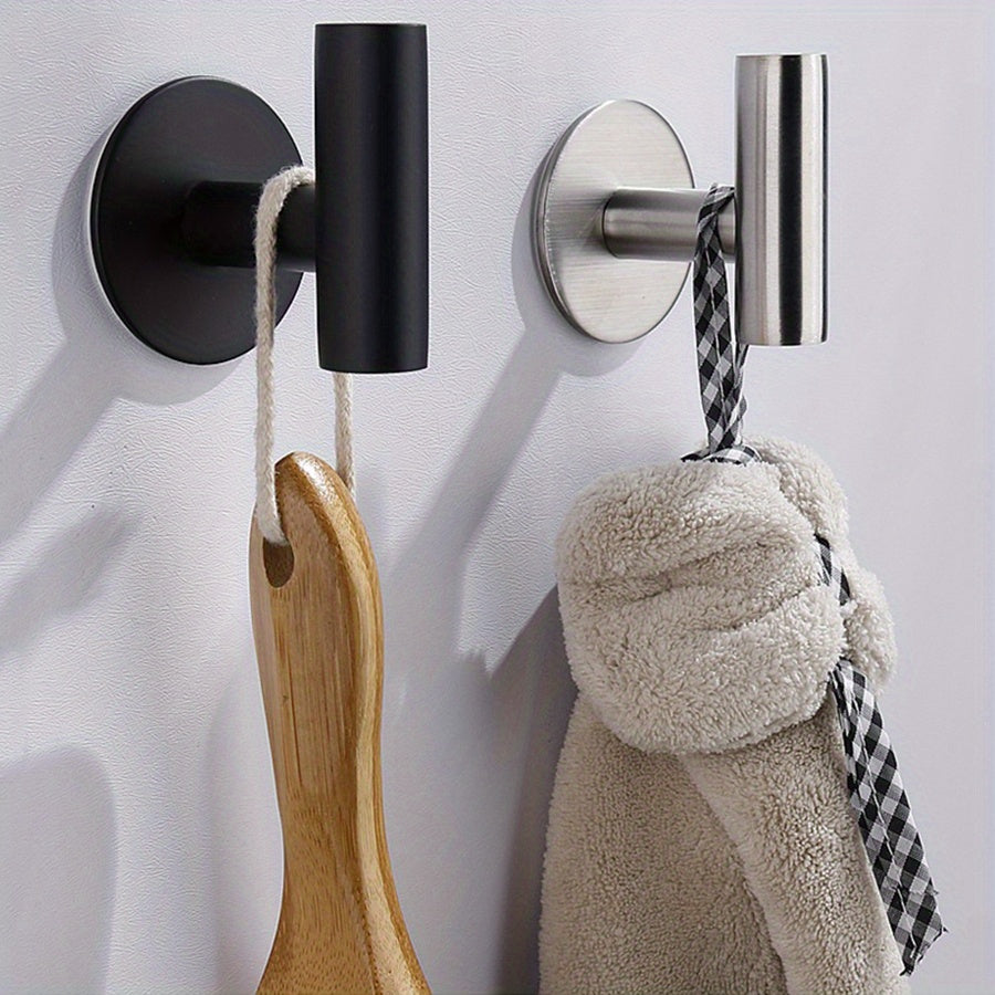 Two sleek black stainless steel self-adhesive hooks for towels and kitchen utensils. Rustproof, no-drill wall mount perfect for home and garage organization.