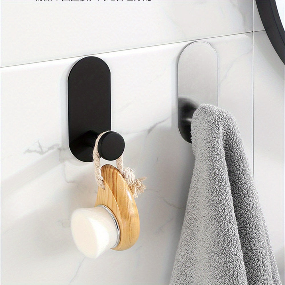 Two sleek black stainless steel self-adhesive hooks for towels and kitchen utensils. Rustproof, no-drill wall mount perfect for home and garage organization.