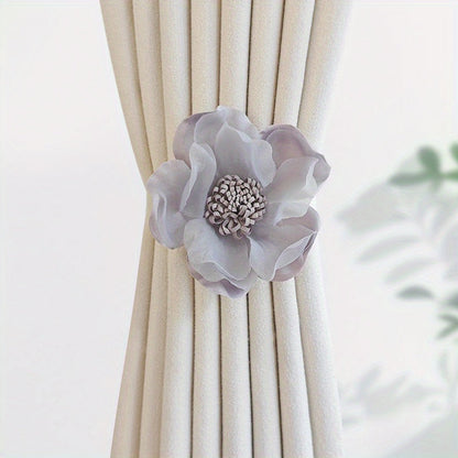 These magnetic curtain straps feature a simple yet stylish three-dimensional flower design. With a magnetic closure, they provide a convenient way to hold back your curtains in the bedroom, living room, kitchen, or any other room in your home. Perfect