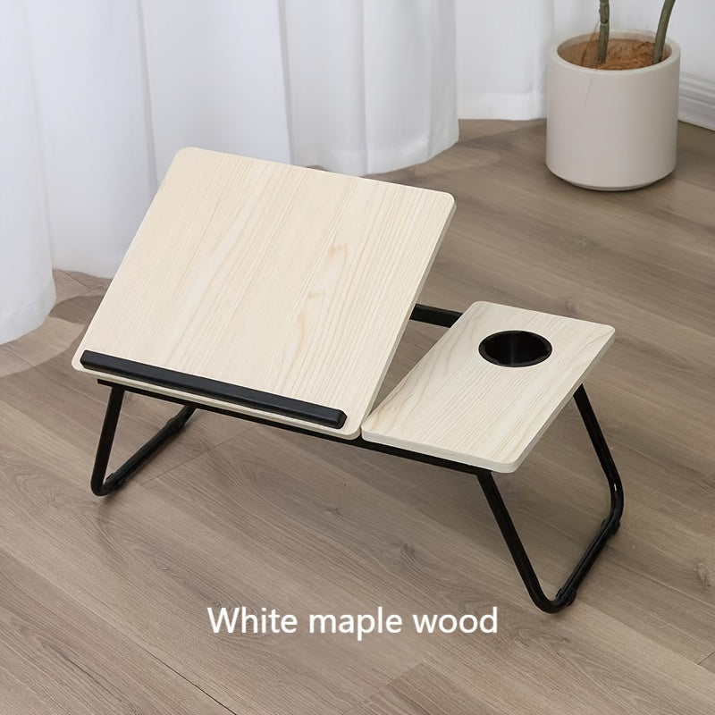 Adjustable bed desk with cup holder for laptop; portable, foldable lap desk for lazy computer use, made of wood fiber board.