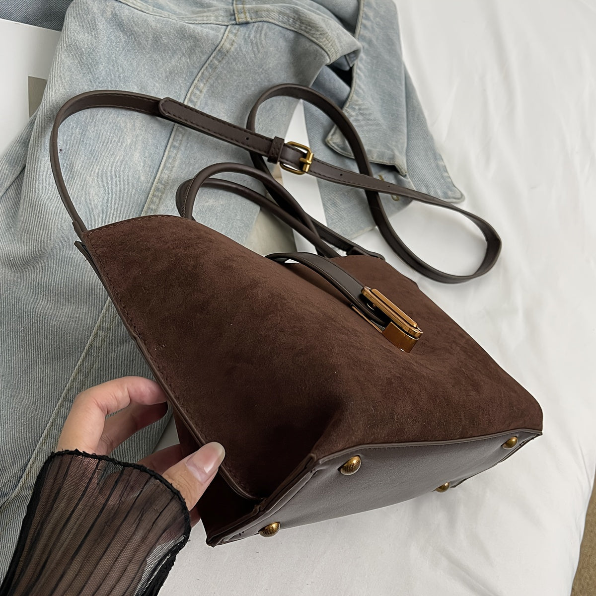 Adjustable shoulder strap tote bag with vintage style and retro large capacity, made from suede leather. Features turn lock closure and unlined fabric material.