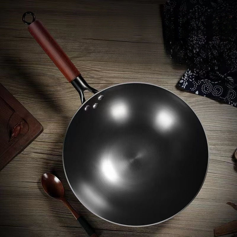 This essential item for home kitchens is the 1-piece Rust-Resistant Cast Iron Skillet with Wooden Handle in Black. With a round bottom design, this wok is perfect for gas stoves and is available in multiple sizes. Made of stainless steel and free of any