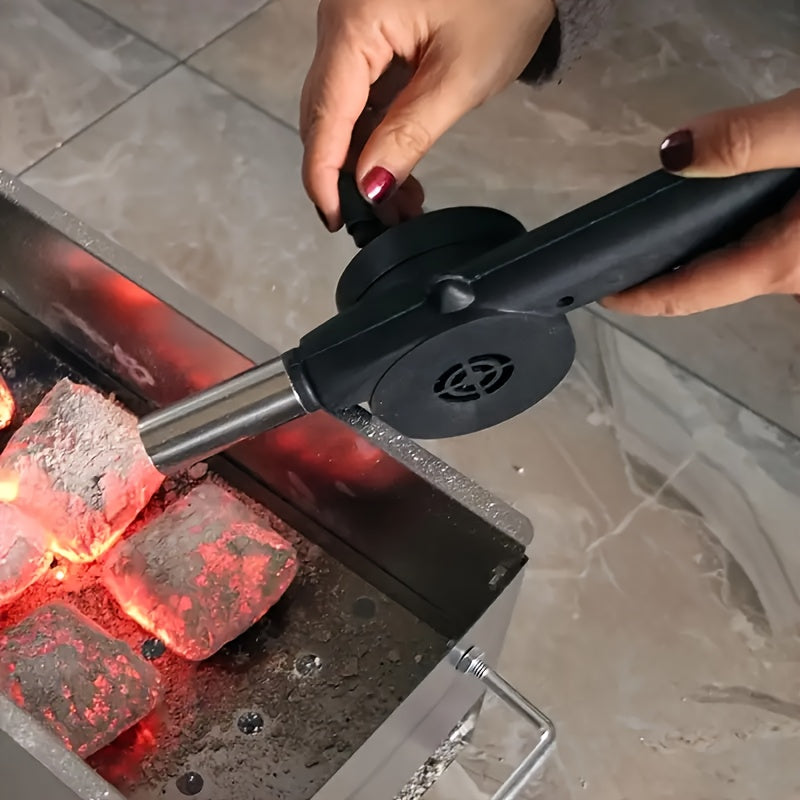 Handheld manual BBQ blower made of durable plastic for outdoor cooking.