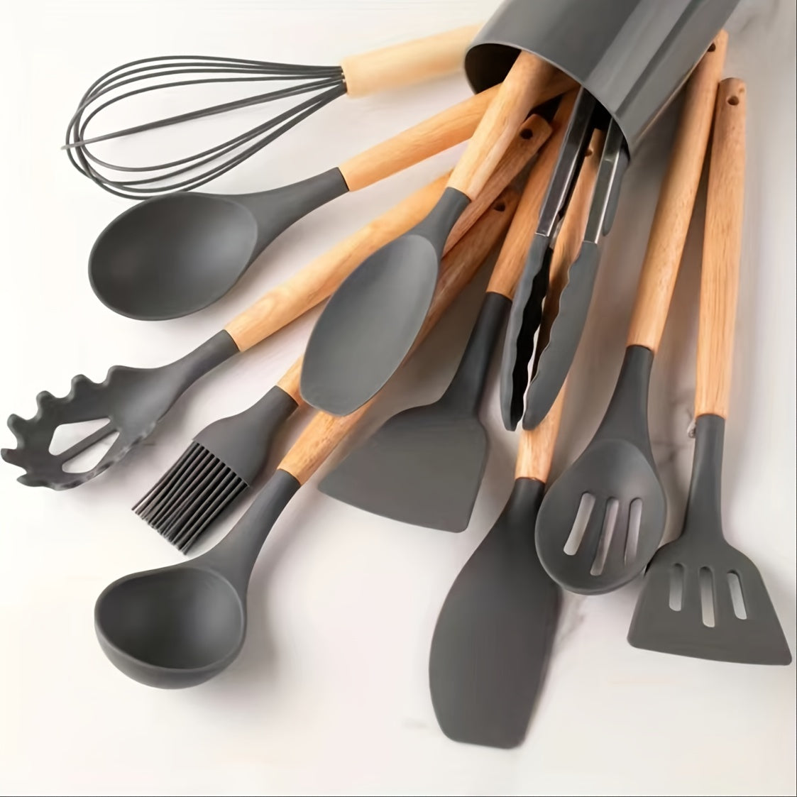 Set of 12 silicone utensils with khaki color and wooden handles, ensuring safety while cooking. These non-stick kitchen tools are washable and modern, providing a range of cookware and gadgets for your kitchen.