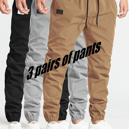 Three-pack of men's loose casual pants in 100% polyester solid color, featuring multi-pocket waist drawstring and non-stretch woven fabric, part of the Spring Collection, 180g/m².