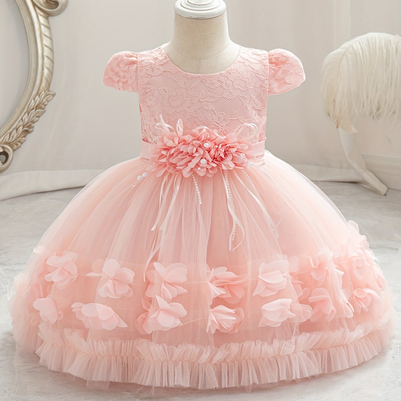 Baby's floral tulle princess dress with lace sleeves for formal occasions.