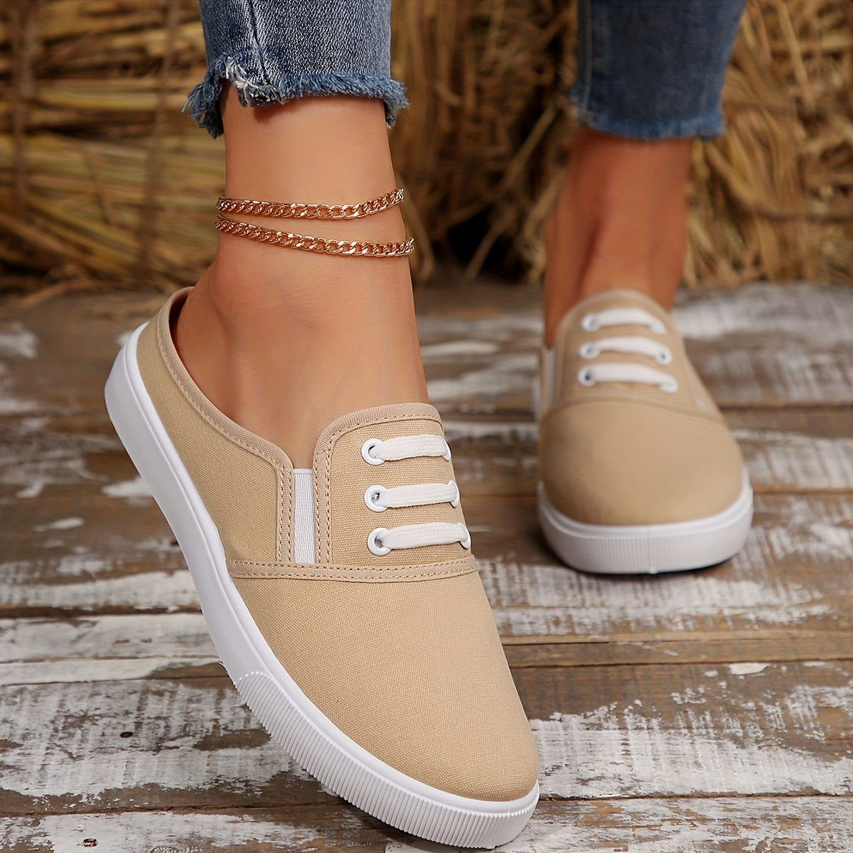 Lightweight white slip-on canvas sneakers for women with a soft sole and minimalist design.