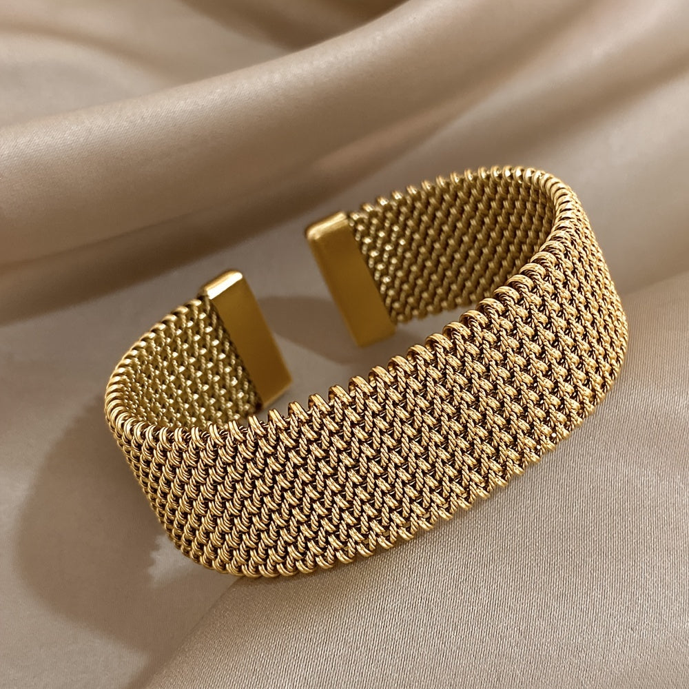 Stylish woven stainless steel bracelet with a golden touch, versatile accessory in trendy golden tone.