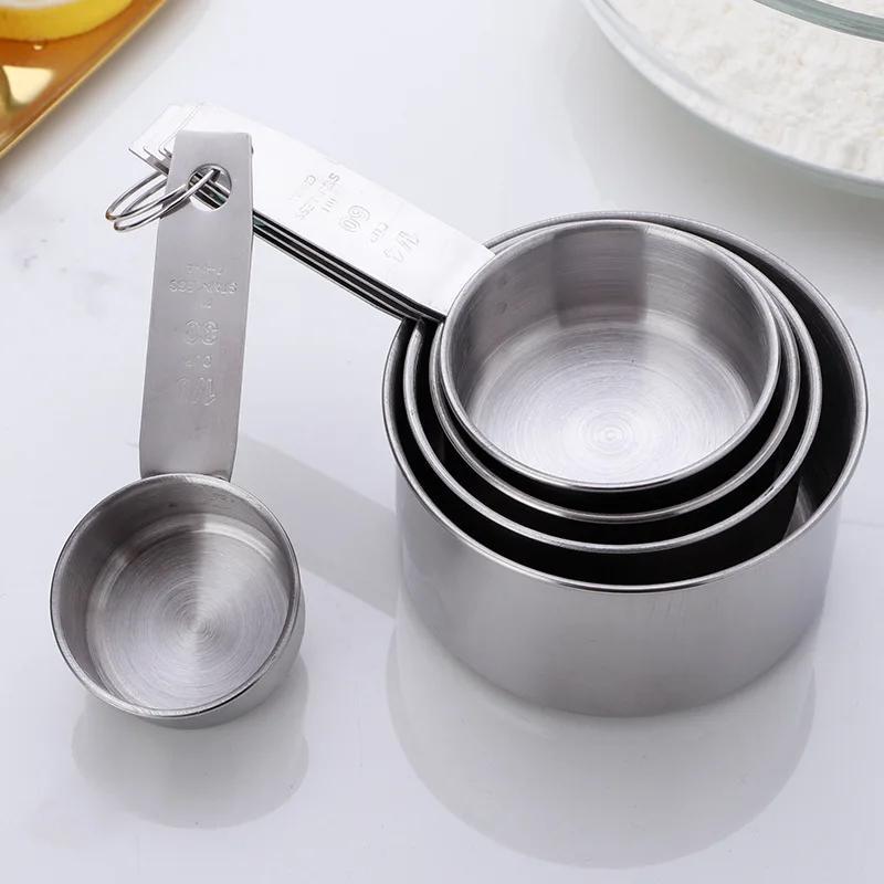 A set of five stainless steel measuring cups and spoons for dry ingredients or liquids, ideal for cooking and baking. Essential kitchen gadgets and tools for all your baking needs.