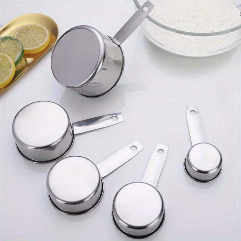 A set of five stainless steel measuring cups and spoons for dry ingredients or liquids, ideal for cooking and baking. Essential kitchen gadgets and tools for all your baking needs.