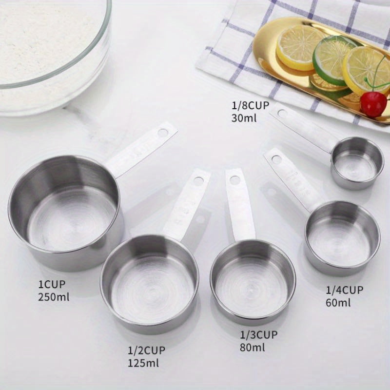 A set of five stainless steel measuring cups and spoons for dry ingredients or liquids, ideal for cooking and baking. Essential kitchen gadgets and tools for all your baking needs.