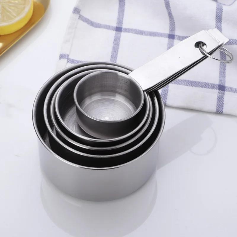 A set of five stainless steel measuring cups and spoons for dry ingredients or liquids, ideal for cooking and baking. Essential kitchen gadgets and tools for all your baking needs.