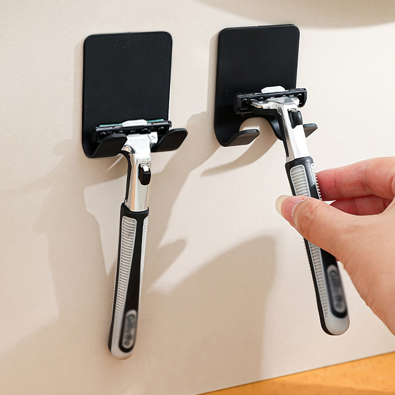 Multifunctional self-adhesive razor hook for bathroom, kitchen, and wardrobe. Pack of 2 or 4.