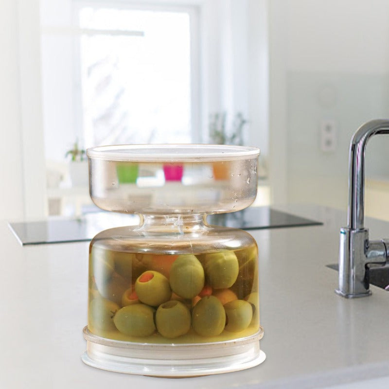 Polycarbonate jar with a flip-top filter net for pickles and olives, featuring a dry and juice separator for kitchen storage and home use. This reusable container keeps your snacks fresh and crisp.