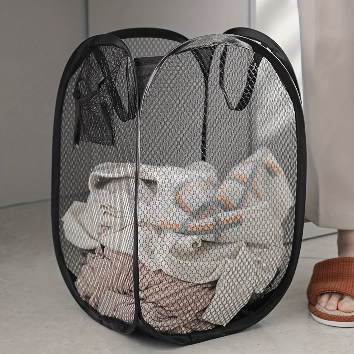 A spacious pop-up laundry hamper with a convenient handle, foldable mesh basket for storing dirty clothes. The perfect household solution and a great gift idea for Easter, Halloween, or Christmas.