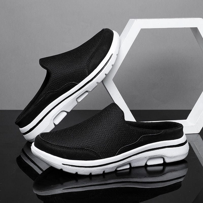 Breathable men's mules in black and white with cushioned insole for comfortable walking.