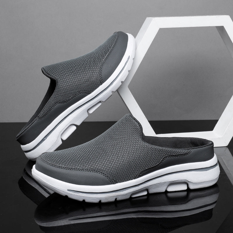 Breathable men's mules in black and white with cushioned insole for comfortable walking.