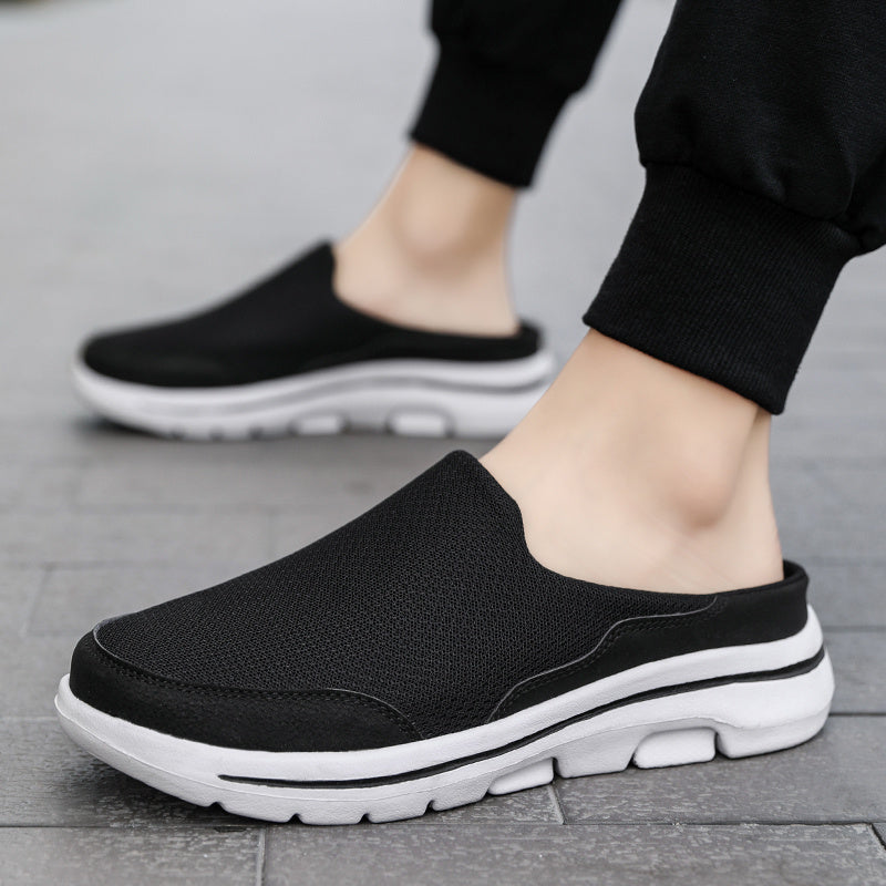 Breathable men's mules in black and white with cushioned insole for comfortable walking.