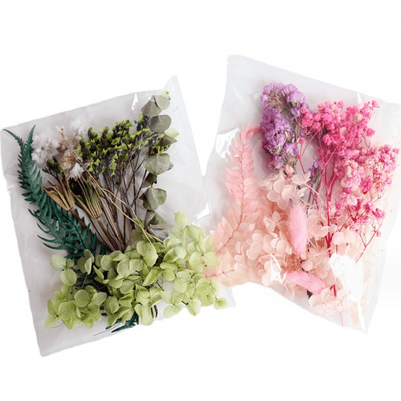 Assorted flowers, preserved materials, and epoxy resin fillers for DIY floral projects.