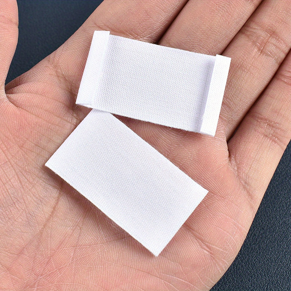 Set of 48 white fabric labels for clothing and packaging decoration.