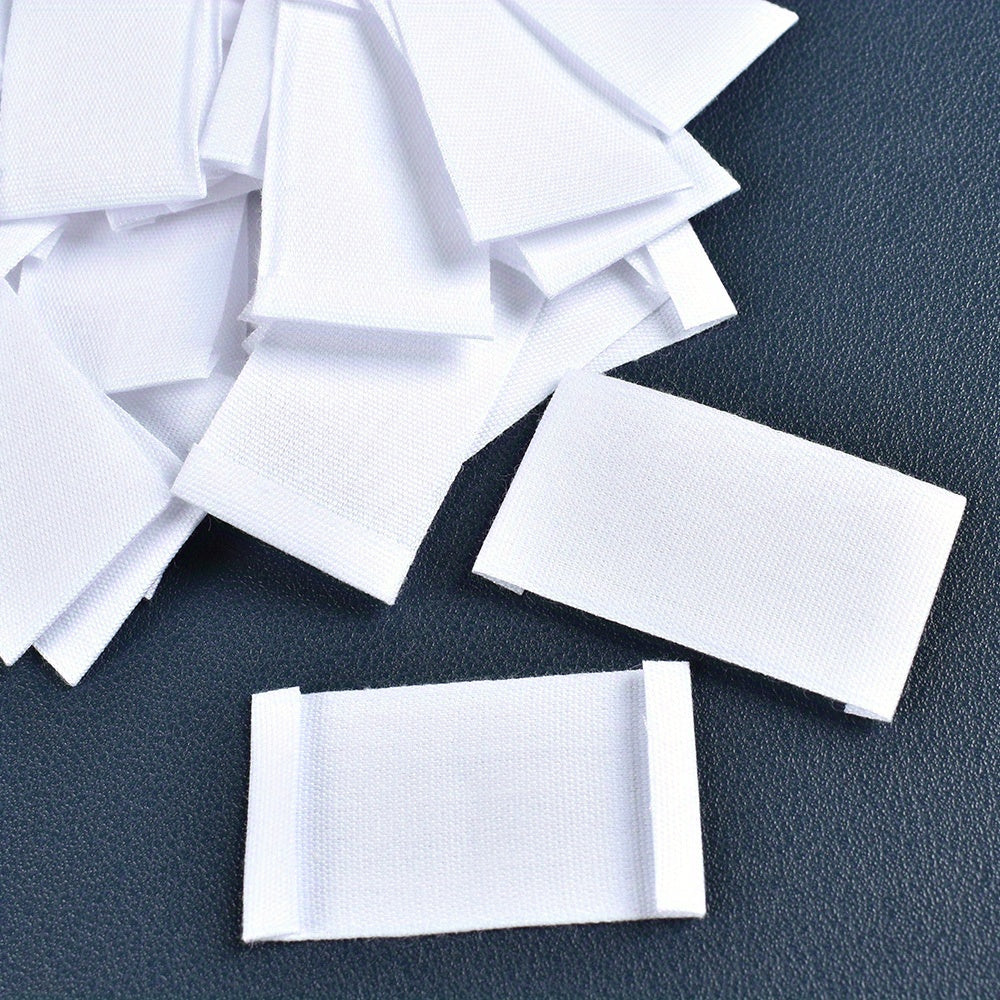 Set of 48 white fabric labels for clothing and packaging decoration.