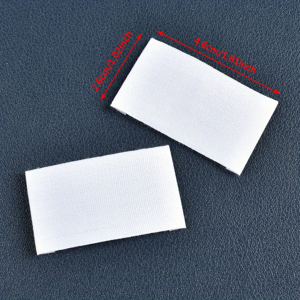 Set of 48 white fabric labels for clothing and packaging decoration.