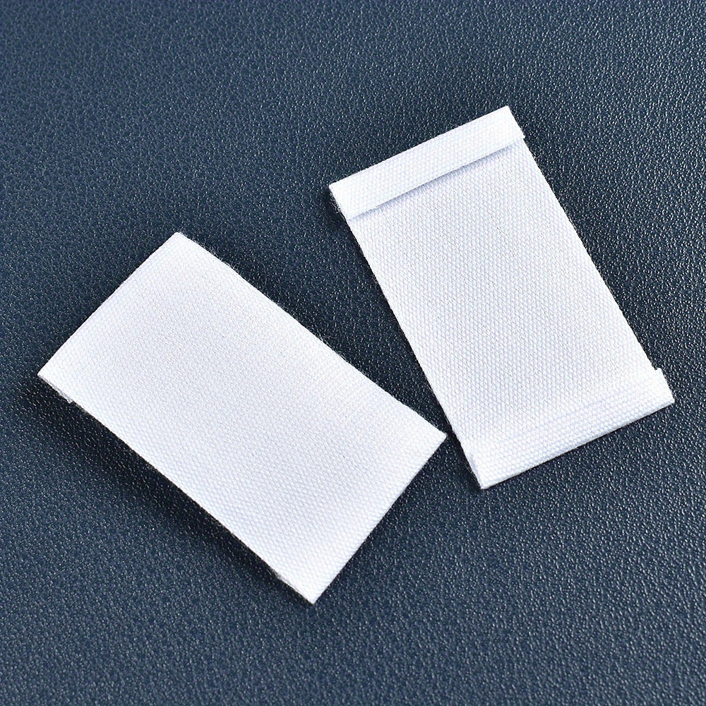 Set of 48 white fabric labels for clothing and packaging decoration.