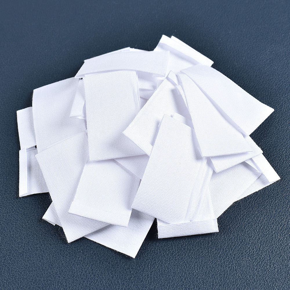 Set of 48 white fabric labels for clothing and packaging decoration.