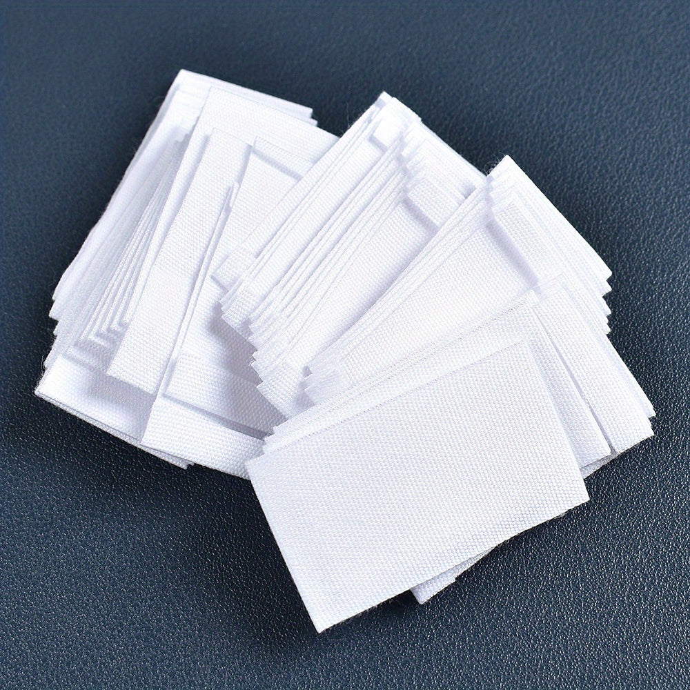 Set of 48 white fabric labels for clothing and packaging decoration.