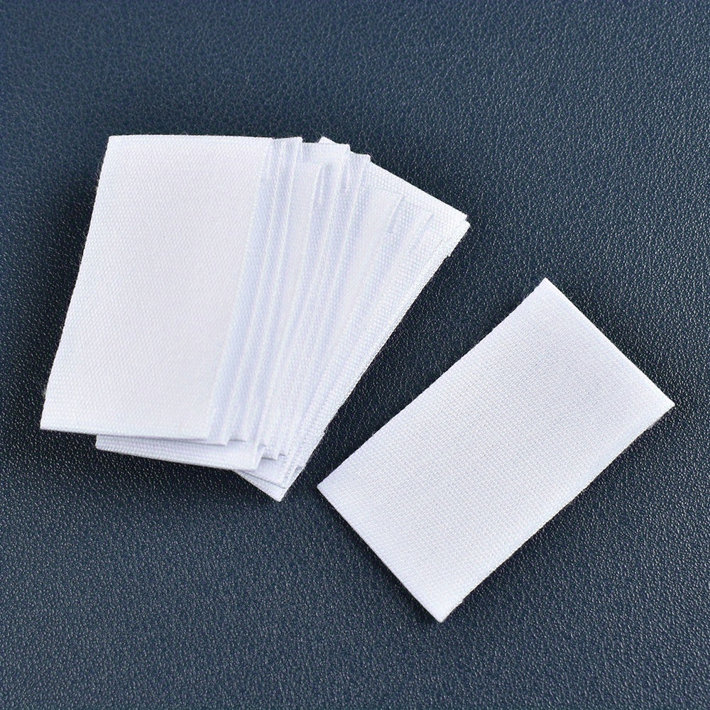 Set of 48 white fabric labels for clothing and packaging decoration.