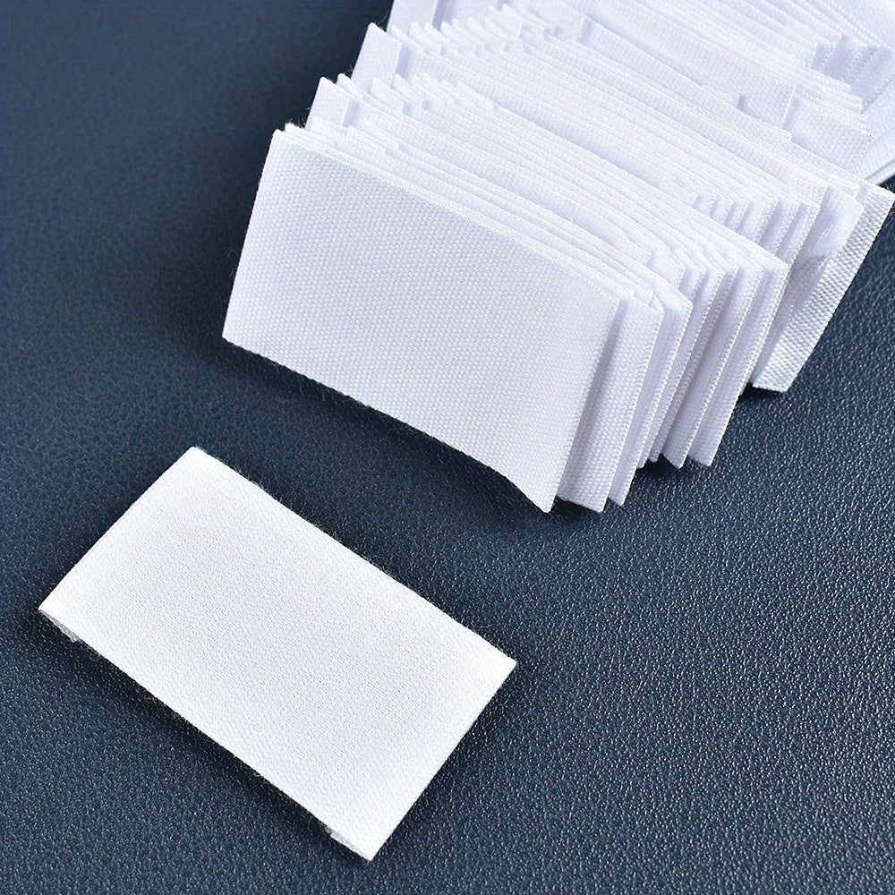 Set of 48 white fabric labels for clothing and packaging decoration.