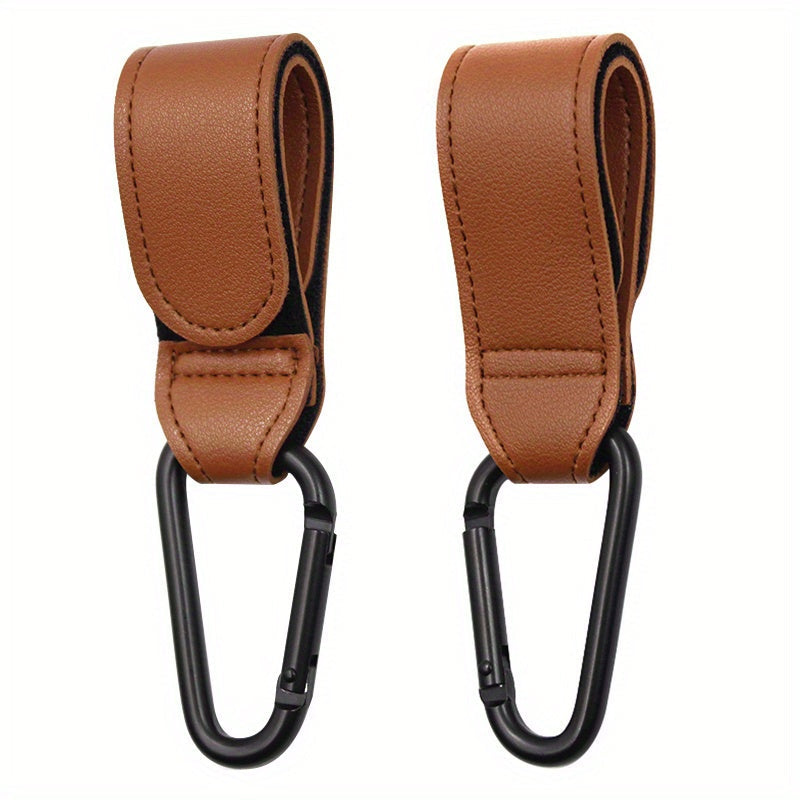 Set of 2 Stroller Hooks for Hanging Diaper Bags, Grocery Shopping Bags, or Pram Straps. The perfect multi-purpose gift for Christmas, Halloween, Thanksgiving, or any occasion. Made of high-quality faux leather.