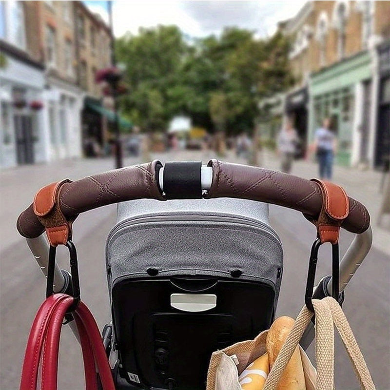 Set of 2 Stroller Hooks for Hanging Diaper Bags, Grocery Shopping Bags, or Pram Straps. The perfect multi-purpose gift for Christmas, Halloween, Thanksgiving, or any occasion. Made of high-quality faux leather.