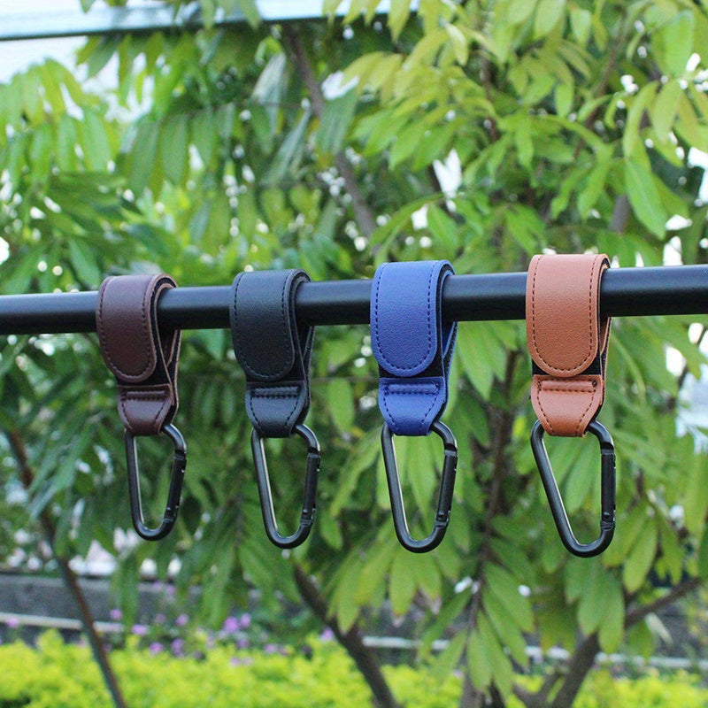 Set of 2 Stroller Hooks for Hanging Diaper Bags, Grocery Shopping Bags, or Pram Straps. The perfect multi-purpose gift for Christmas, Halloween, Thanksgiving, or any occasion. Made of high-quality faux leather.