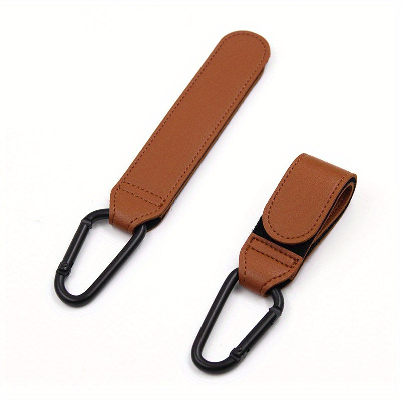 Set of 2 Stroller Hooks for Hanging Diaper Bags, Grocery Shopping Bags, or Pram Straps. The perfect multi-purpose gift for Christmas, Halloween, Thanksgiving, or any occasion. Made of high-quality faux leather.