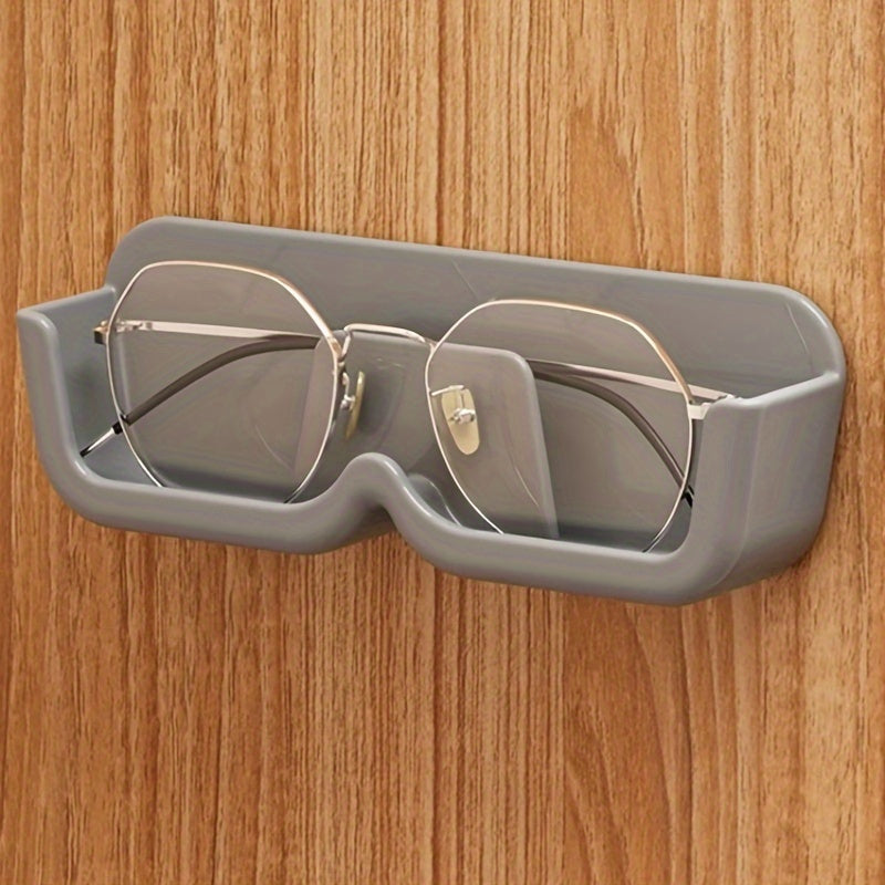 Wall-mounted sunglasses display rack for organizing and storing glasses.