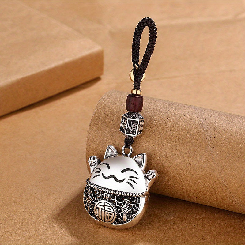 Essential accessories for both men and women with a minimalist ethnic design, including a Chinese-inspired lucky cat and copper coins to bring in prosperity, along with a whimsical cartoon cat pendant specially for the ladies.