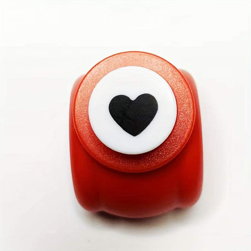 Mini heart-shaped paper punch in red for DIY crafts.