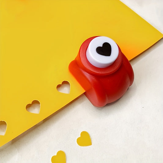 Mini heart-shaped paper punch in red for DIY crafts.