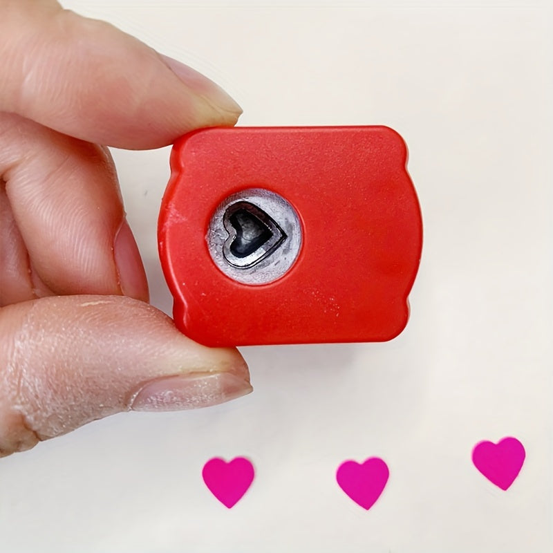 Mini heart-shaped paper punch in red for DIY crafts.