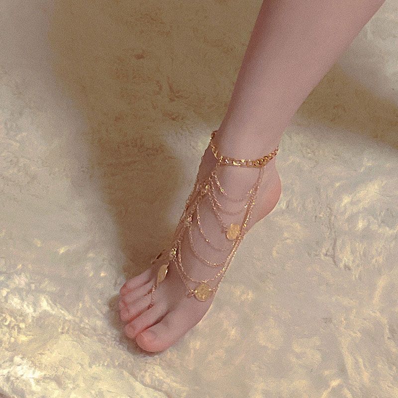 Beautiful and Alluring Foot Chain Tassel Anklet with Toe Ring, featuring Exotic Retro Style with Metal Coin Pendant and Elegant Court Design, perfect for a touch of glamour and sophistication in your jewelry collection.